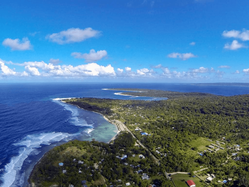 Wide aerial view of Pango Road coastline stretching along the ocean, Port Vila, Vanuatu
